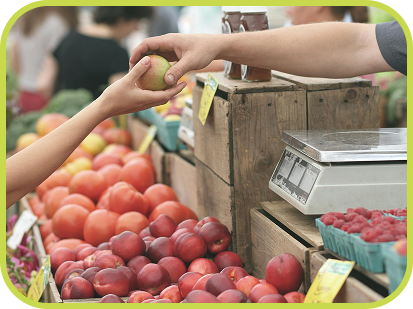 Person handing customer an apple.